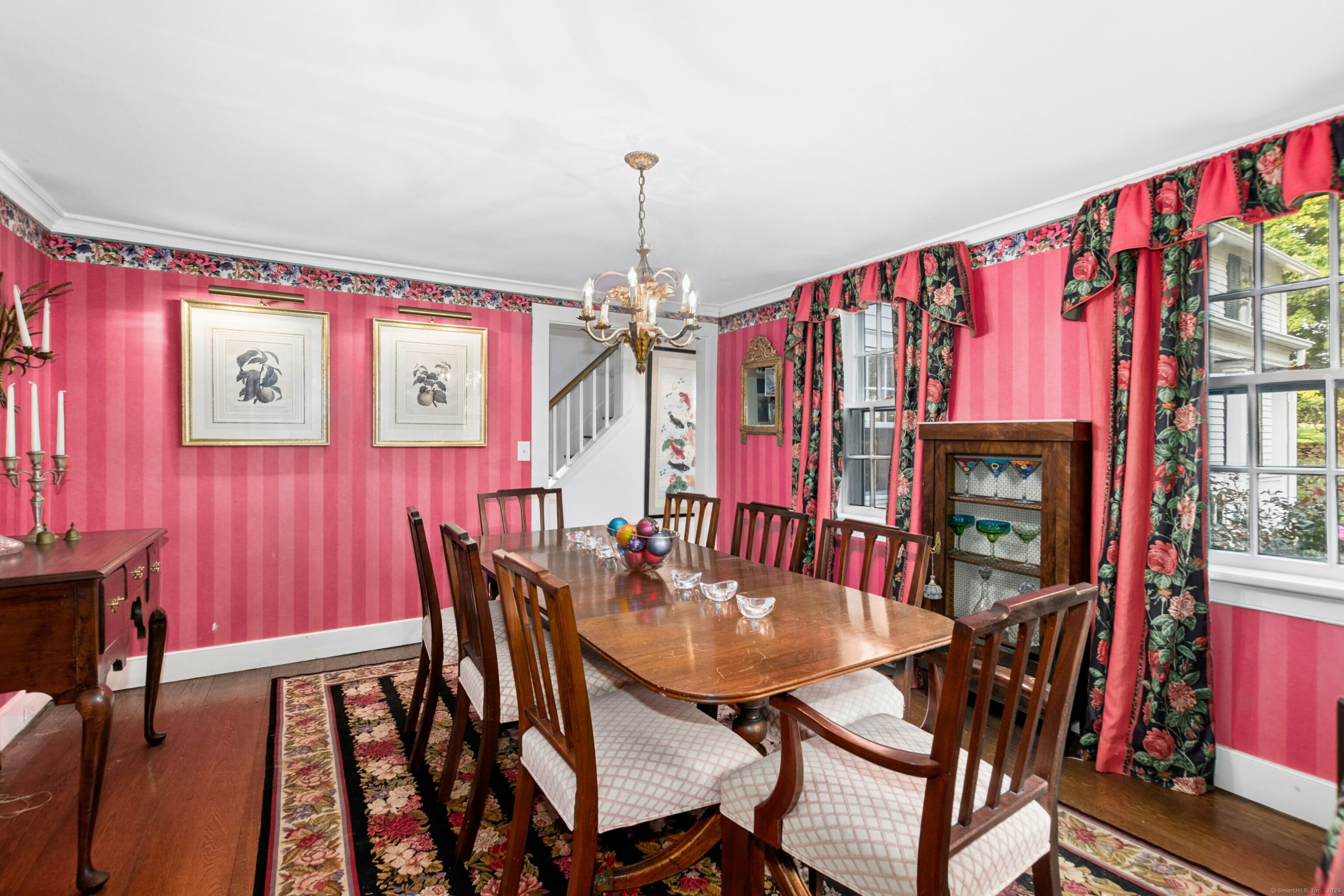 561 Middlesex Road Darien, CT 06820 - Photo 12 of 33 a dining room with furniture a chandelier and wooden floor