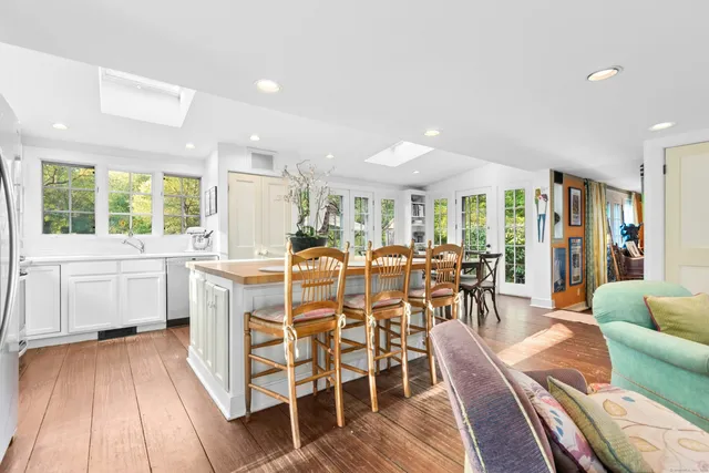 a dining room with furniture window and wooden floor
