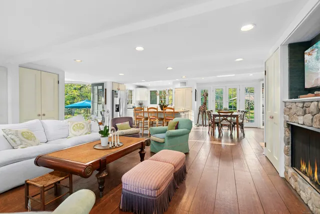 a living room with furniture kitchen view and a fireplace