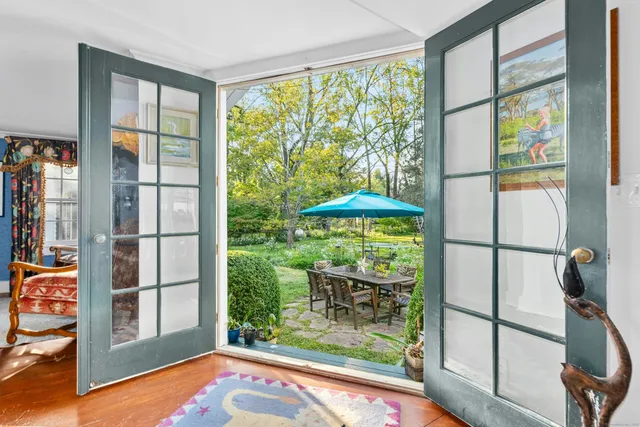 a view of a porch with furniture and backyard