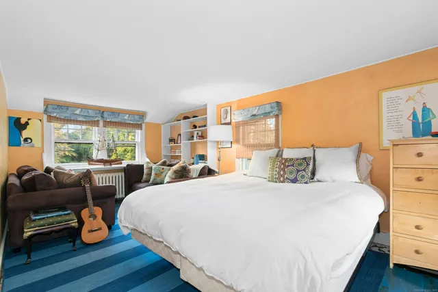 a bedroom with two beds and a couch