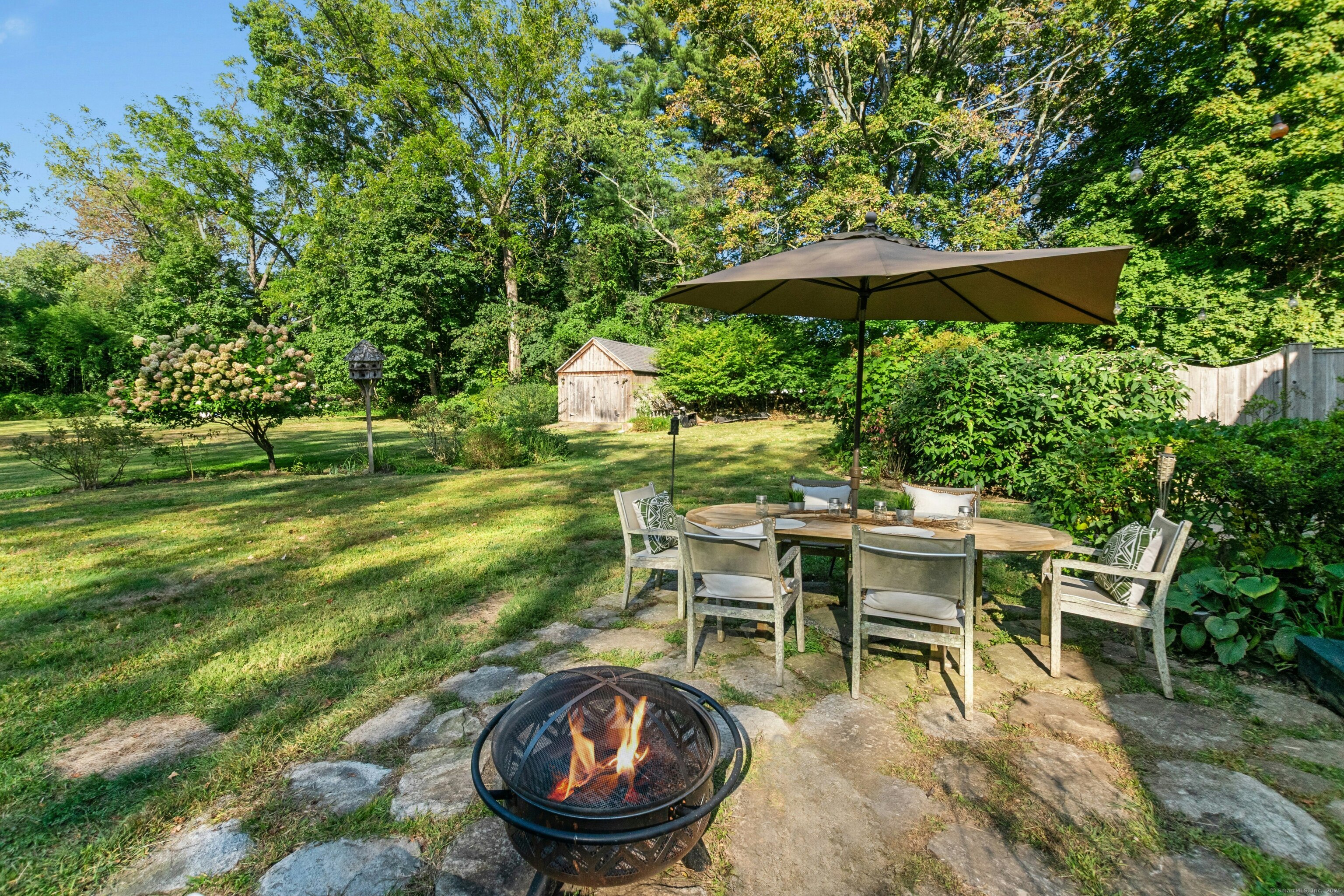 561 Middlesex Road Darien, CT 06820 - Photo 28 of 33 an outdoor space with furniture and umbrella