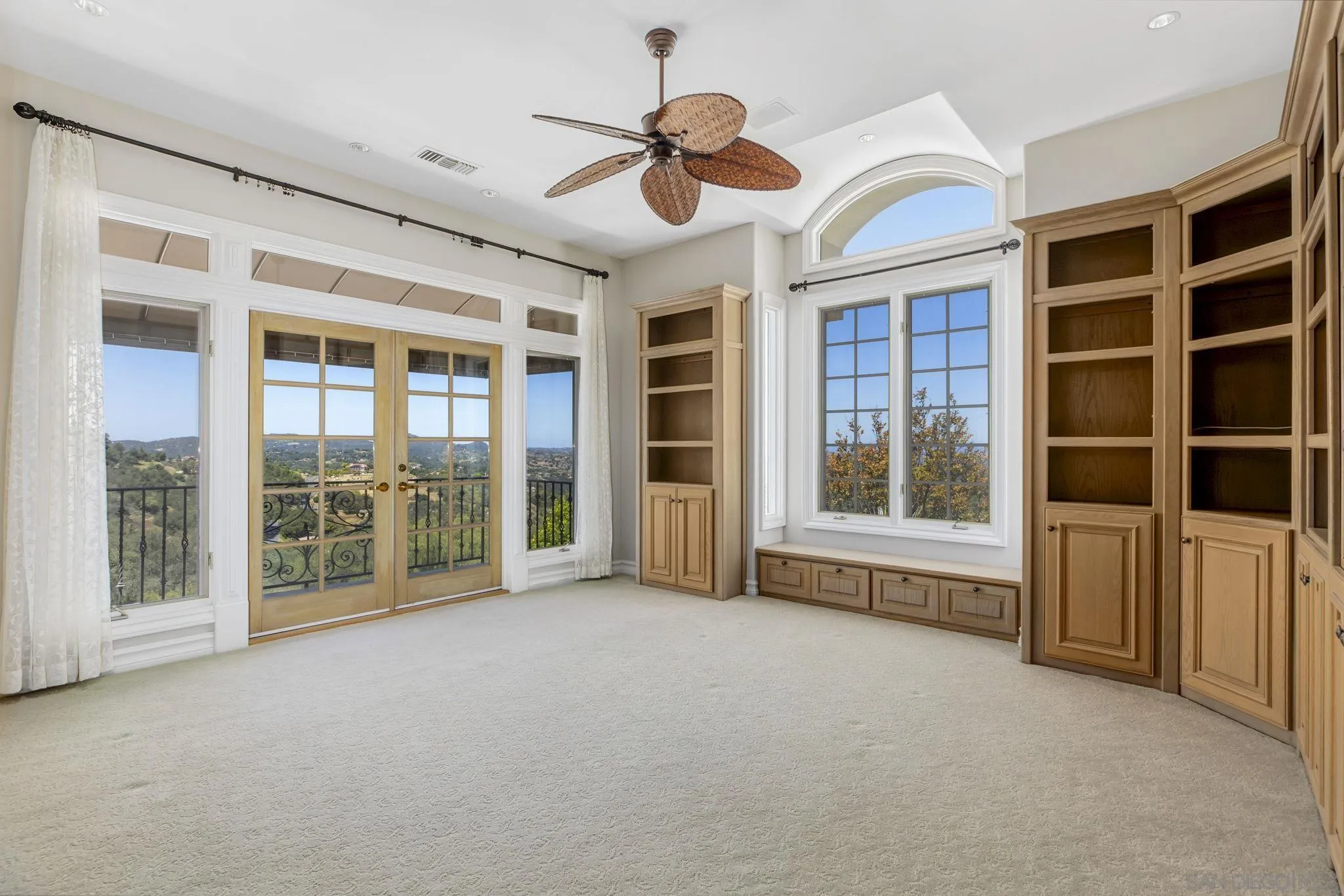 14440 Ridge Ranch Road Valley Center, CA 92082 - Photo 47 of 73 a view of an empty room with a window and a ceiling fan