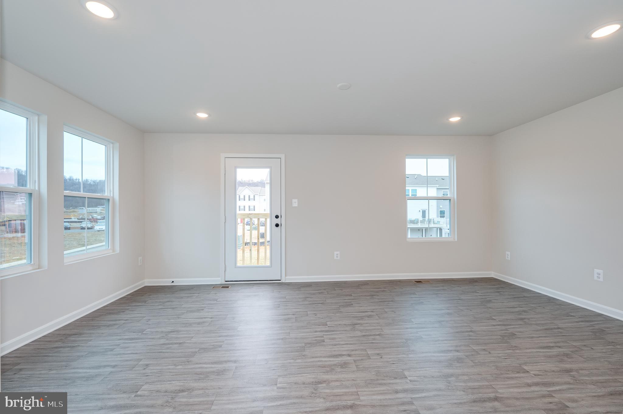 164 Rabbit Road Hedgesville, WV 25427 - Photo 15 of 42 an empty room with wooden floor and windows