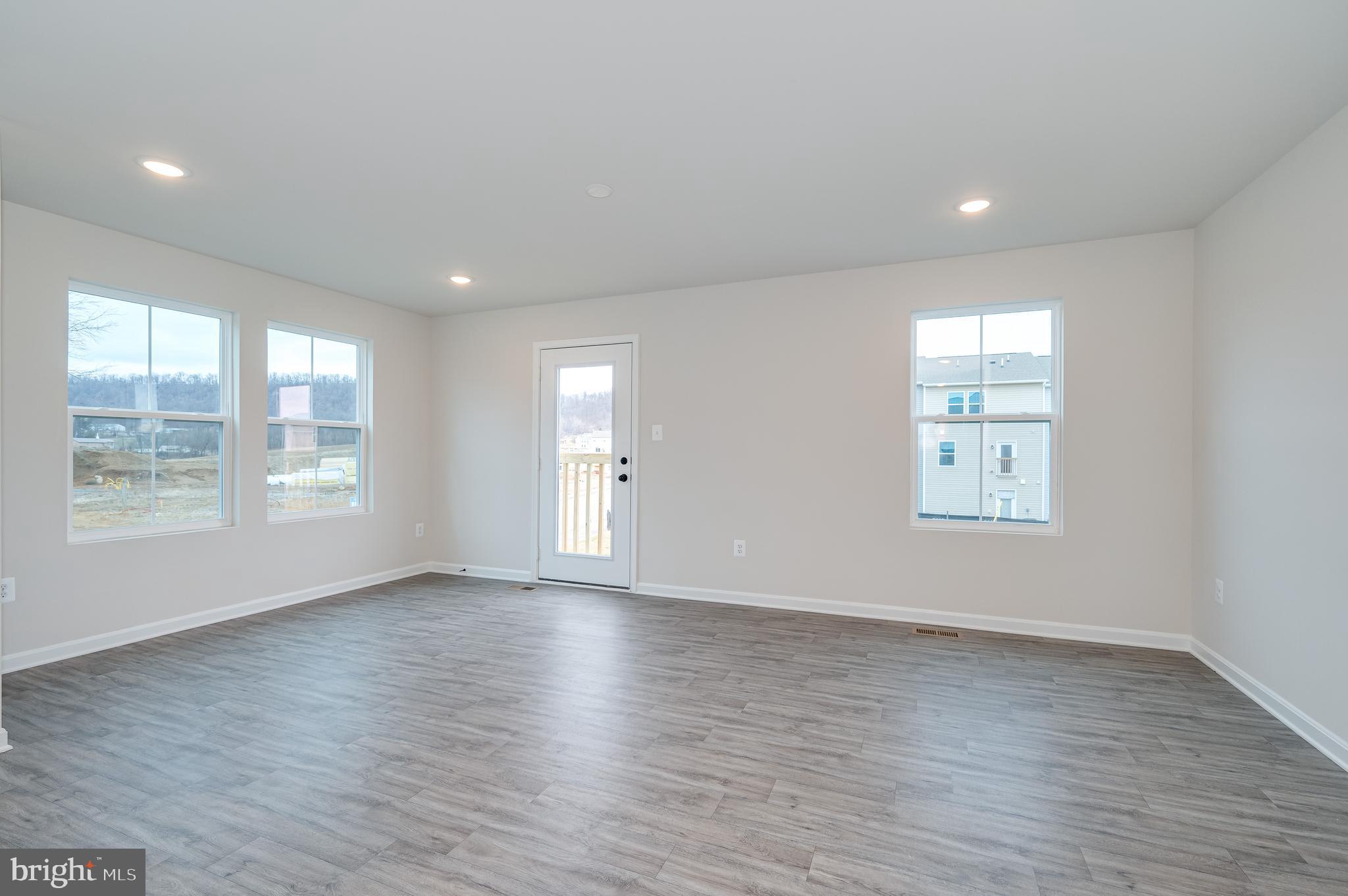 164 Rabbit Road Hedgesville, WV 25427 - Photo 17 of 42 an empty room with wooden floor and windows