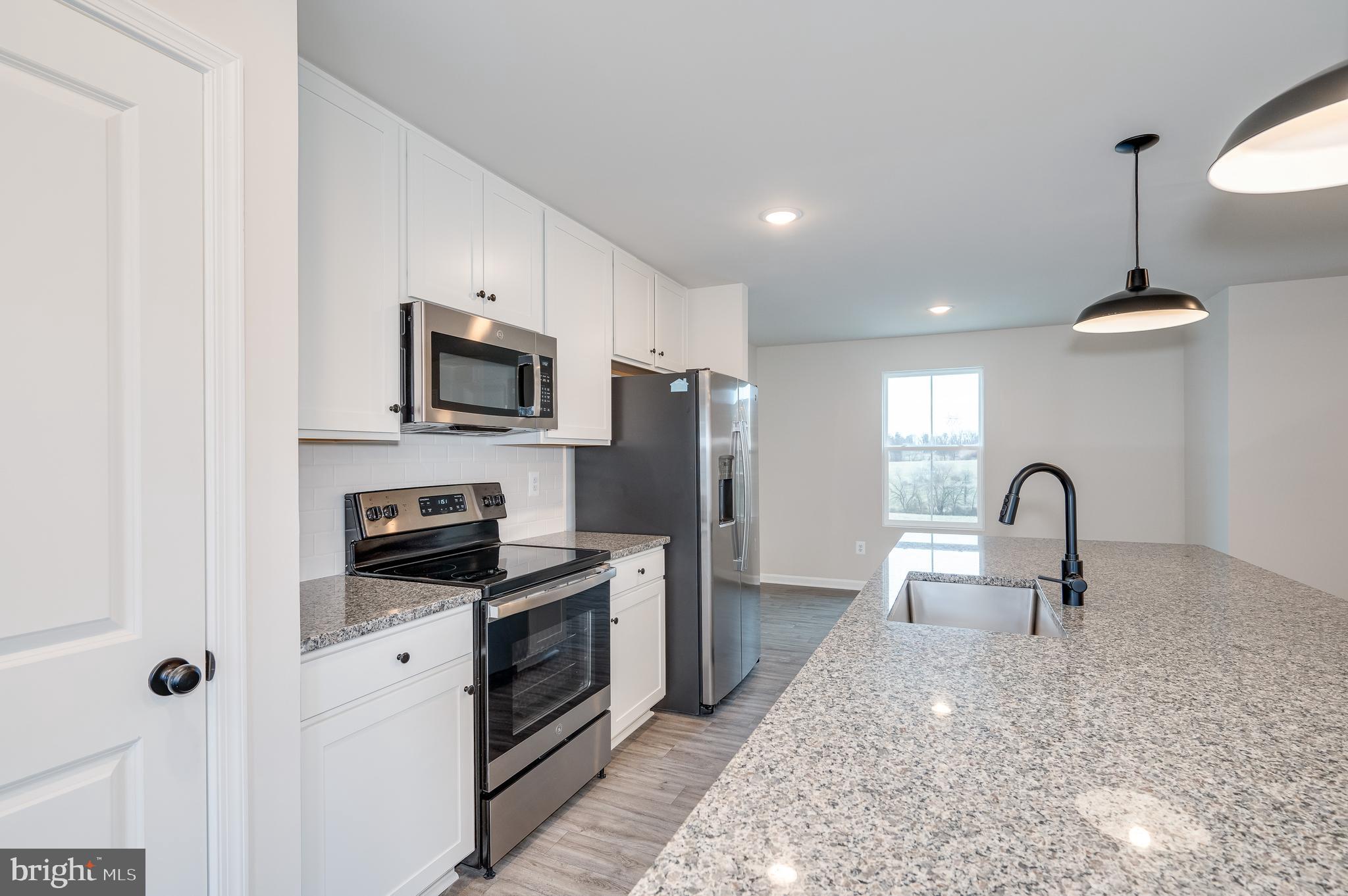 164 Rabbit Road Hedgesville, WV 25427 - Photo 21 of 42 a kitchen with granite countertop a stove and a sink