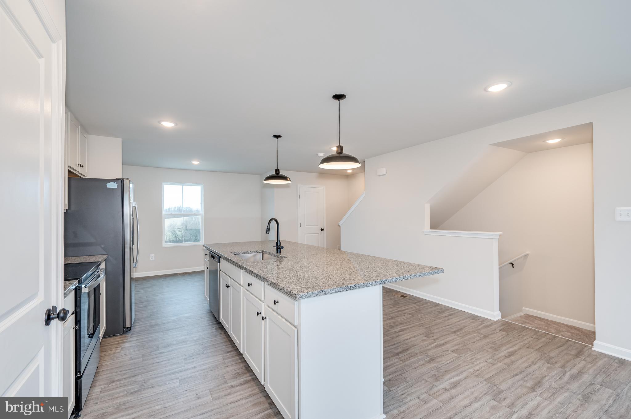 164 Rabbit Road Hedgesville, WV 25427 - Photo 22 of 42 a kitchen with stainless steel appliances granite countertop a sink a refrigerator and a stove