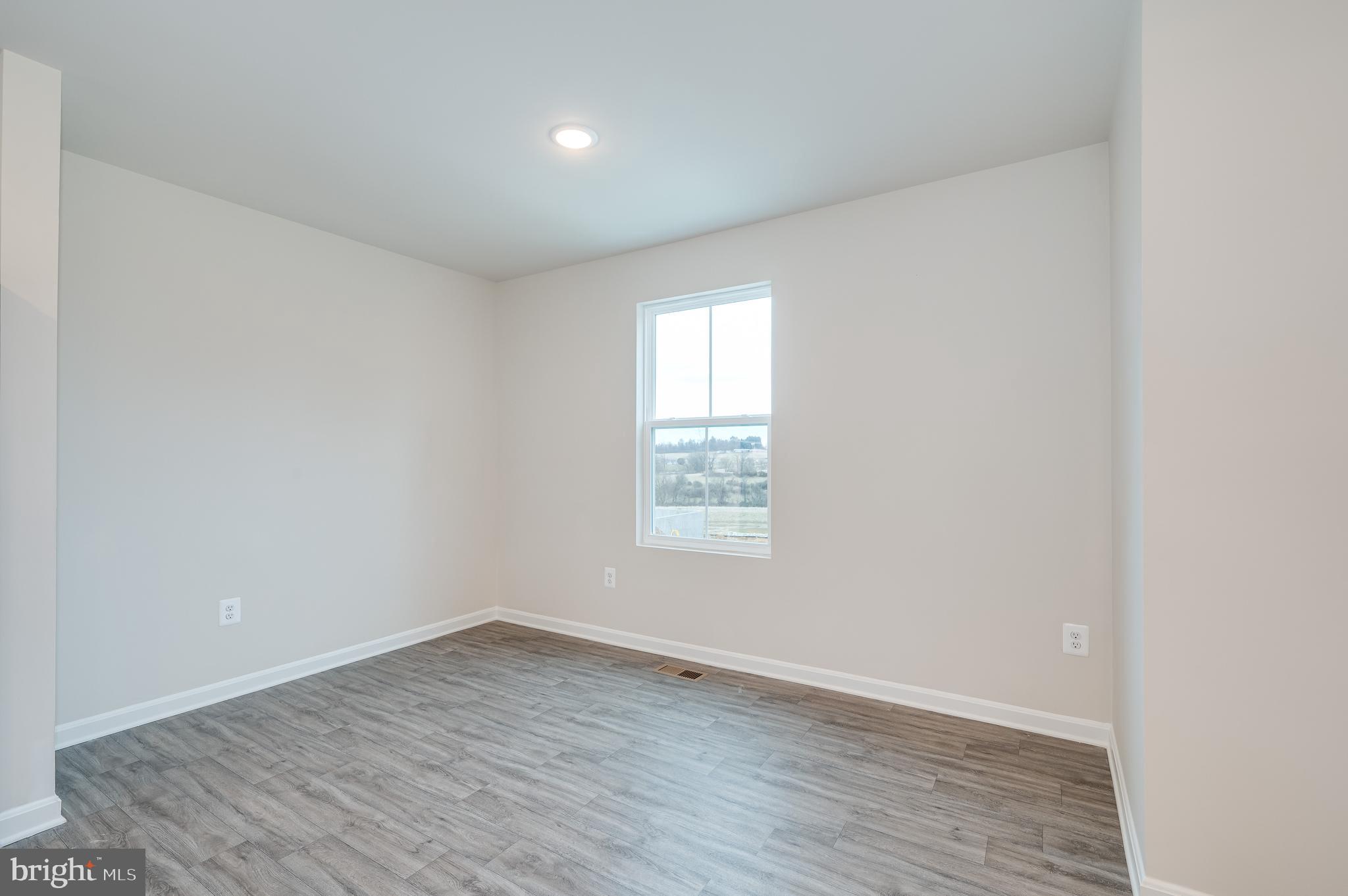 164 Rabbit Road Hedgesville, WV 25427 - Photo 26 of 42 an empty room with wooden floor and window