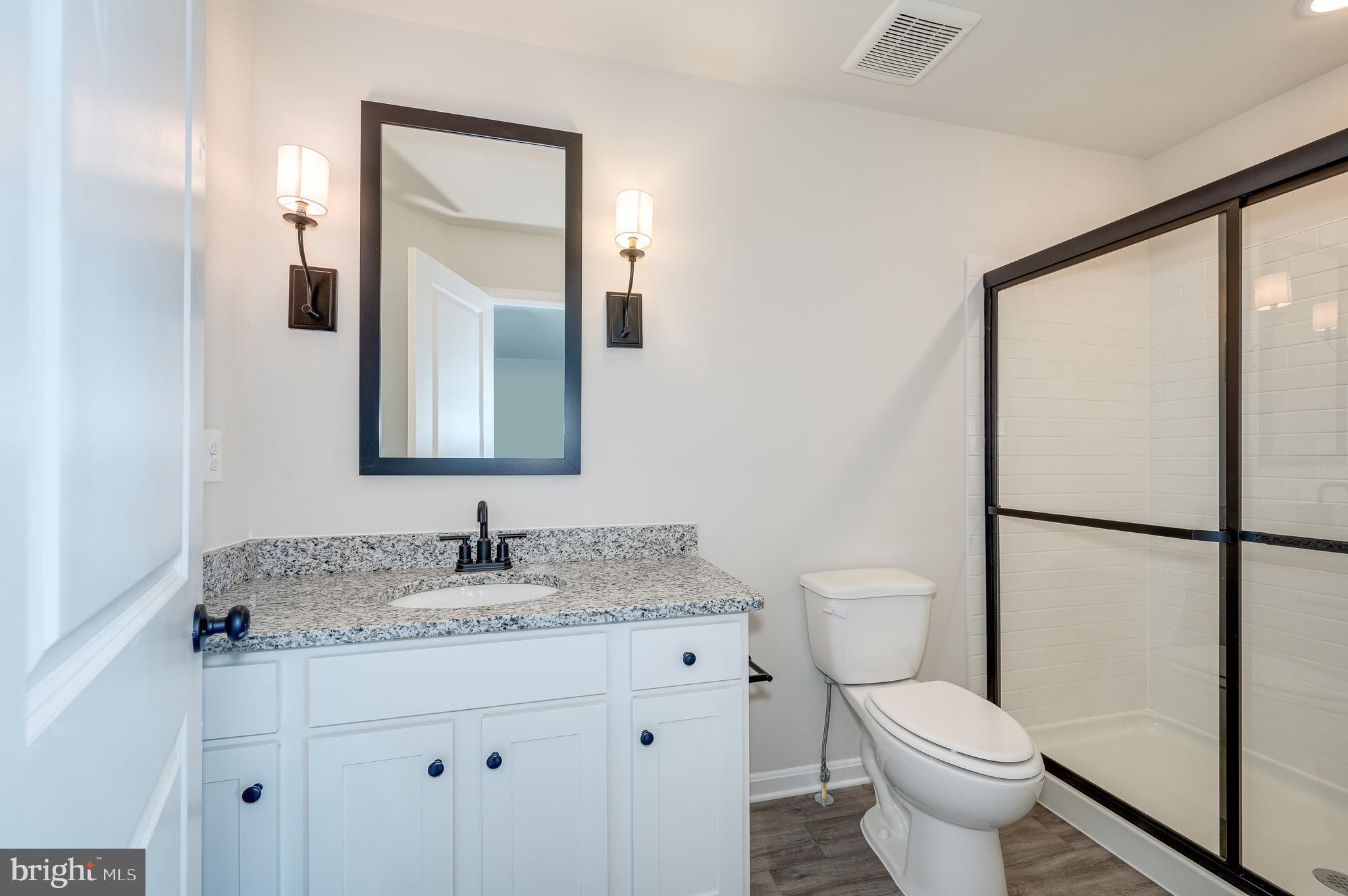 164 Rabbit Road Hedgesville, WV 25427 - Photo 33 of 42 a bathroom with a granite countertop sink toilet and mirror