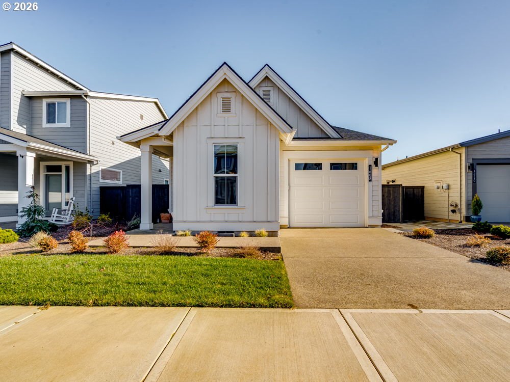 a front view of a house with garden and garage