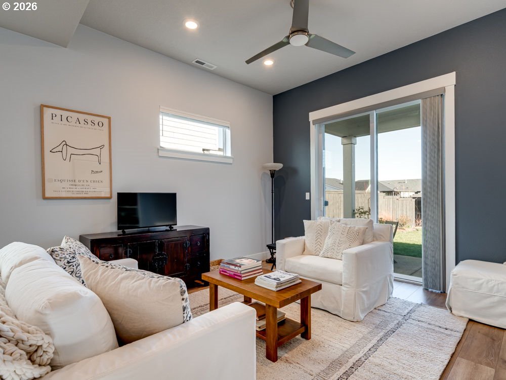 1608 South Fern Way Canby, OR 97013 - Photo 19 of 39 a living room with furniture a chandelier and a flat screen tv