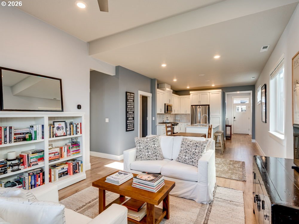 1608 South Fern Way Canby, OR 97013 - Photo 21 of 39 a living room with furniture and a book shelf