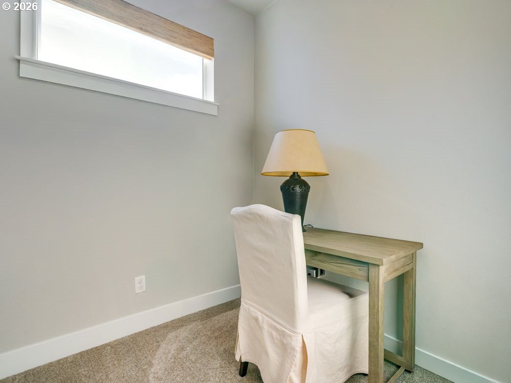 1608 South Fern Way Canby, OR 97013 - Photo 25 of 39 a table and chair in a room next to a window