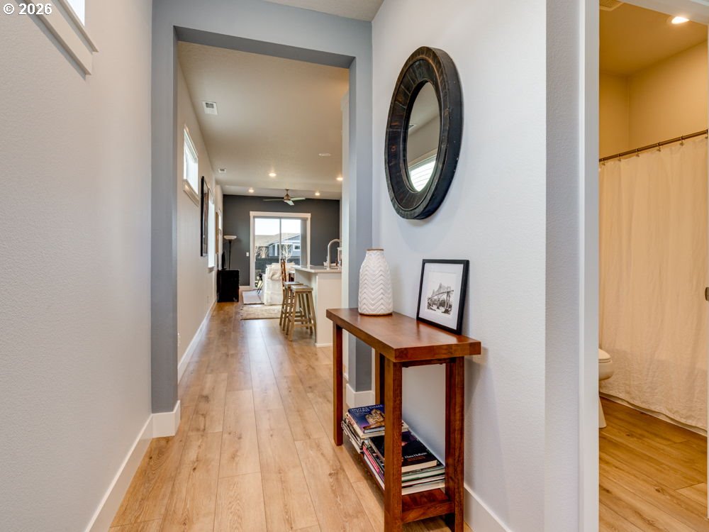 1608 South Fern Way Canby, OR 97013 - Photo 8 of 39 a view of a hallway with wooden floor and a potted plant