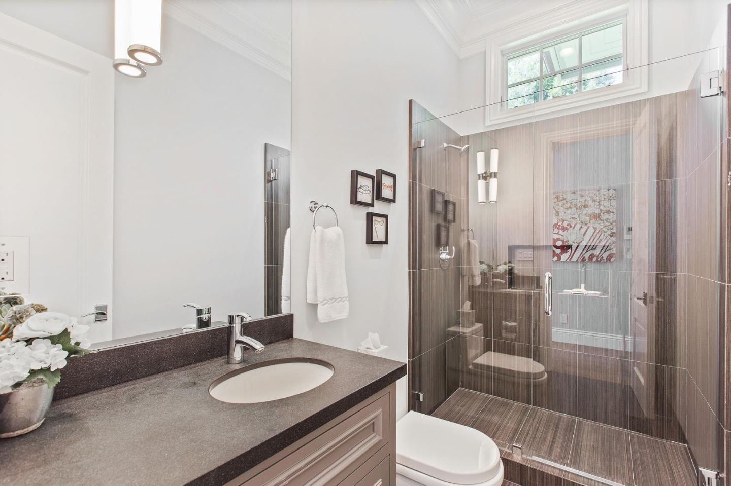 250 Bridge Road Hillsborough, CA 94010 - Photo 26 of 80 a bathroom with a granite countertop sink toilet a mirror and shower