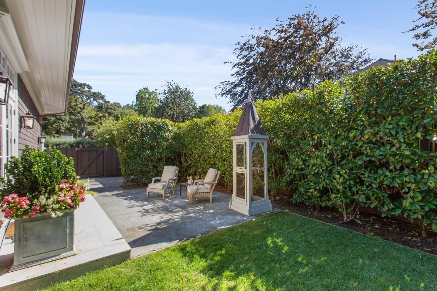 250 Bridge Road Hillsborough, CA 94010 - Photo 51 of 80 a view of a patio with table and chairs potted plants and large tree