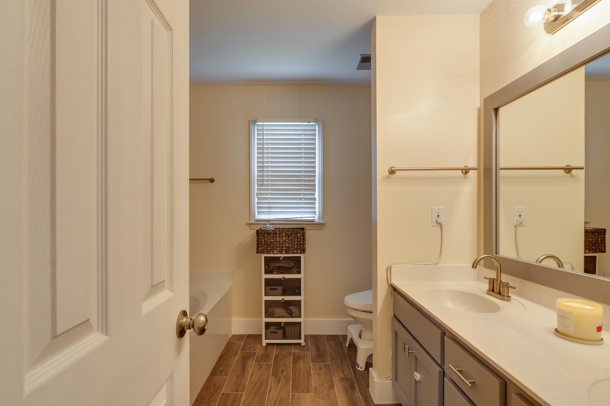 8703 Old River Road Memphis, TN 38018 - Photo 20 of 31 Full bath featuring vanity, a tub to relax in, and wood finished floors