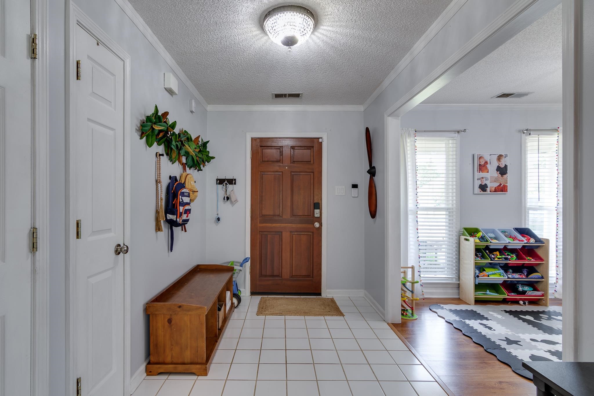 8703 Old River Road Memphis, TN 38018 - Photo 2 of 31 Foyer featuring a textured ceiling, ornamental molding, and light tile patterned floors