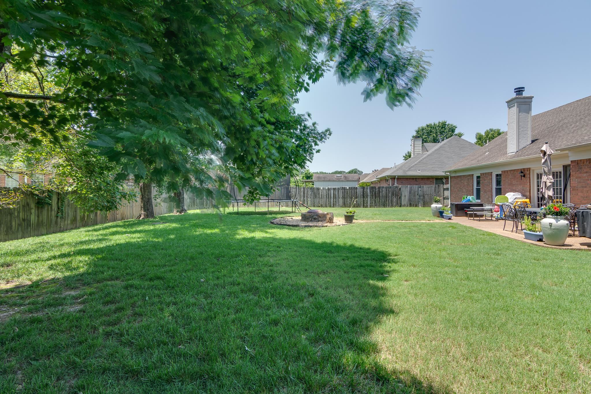 8703 Old River Road Memphis, TN 38018 - Photo 28 of 31 Fenced backyard with a patio and a fire pit