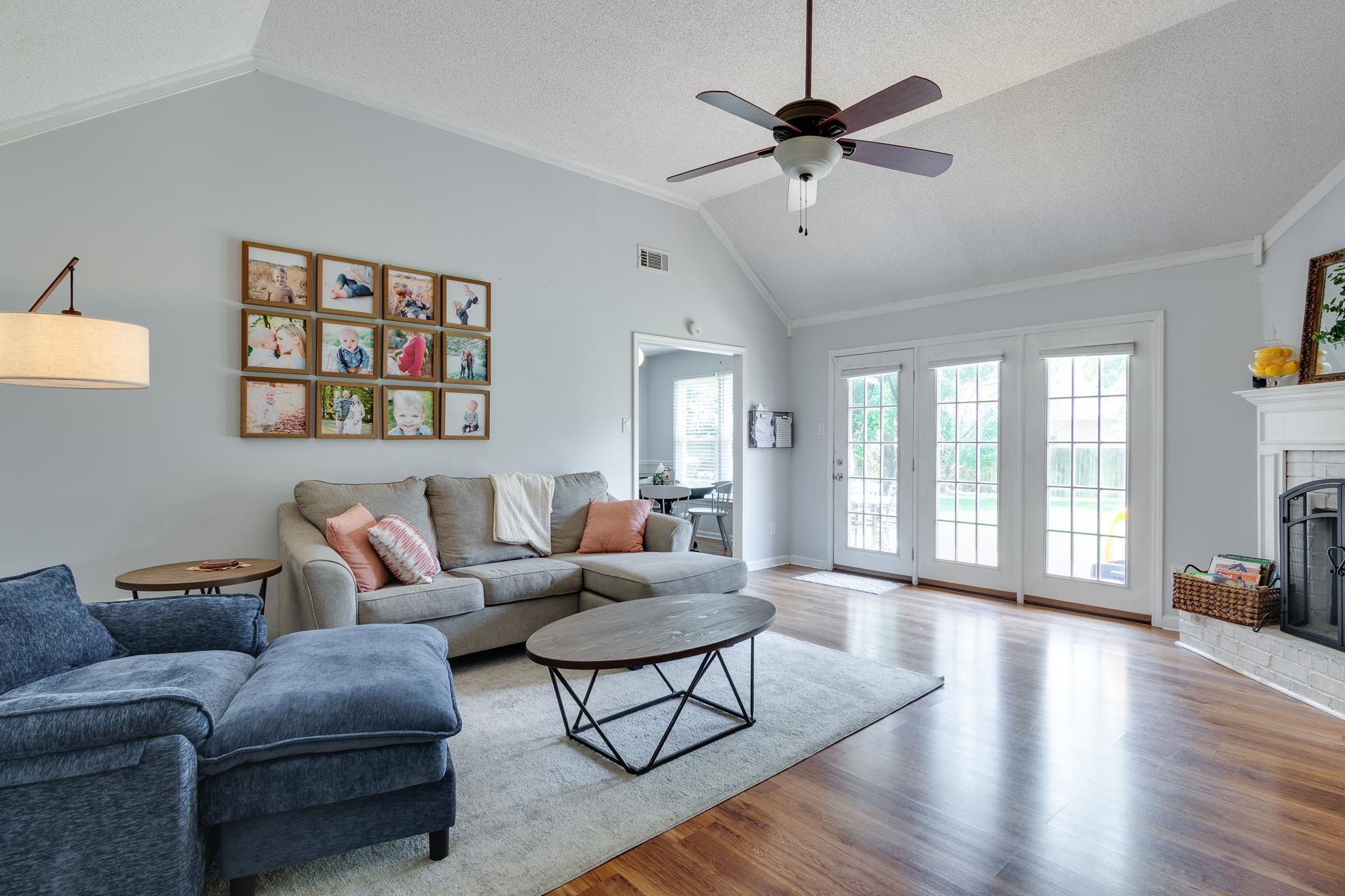 8703 Old River Road Memphis, TN 38018 - Photo 6 of 31 Living room featuring lofted ceiling, wood finished floors, plenty of natural light, ceiling fan, and a textured ceiling