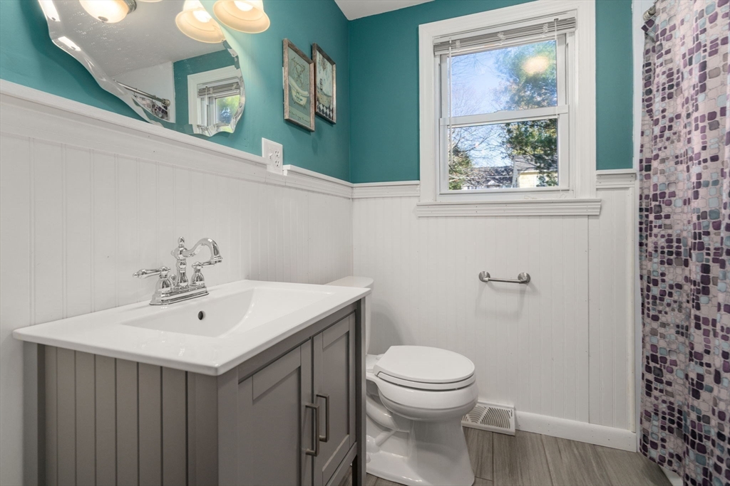 102 Montgomery Avenue Lowell, MA 01851 - Photo 13 of 40 a bathroom with a toilet a sink and a mirror
