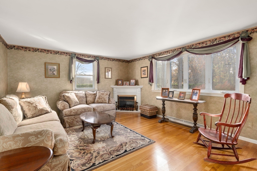 102 Montgomery Avenue Lowell, MA 01851 - Photo 15 of 40 a living room with furniture a fireplace and a floor to ceiling window