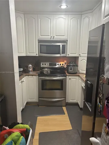 a kitchen with stainless steel appliances a stove a sink and a refrigerator