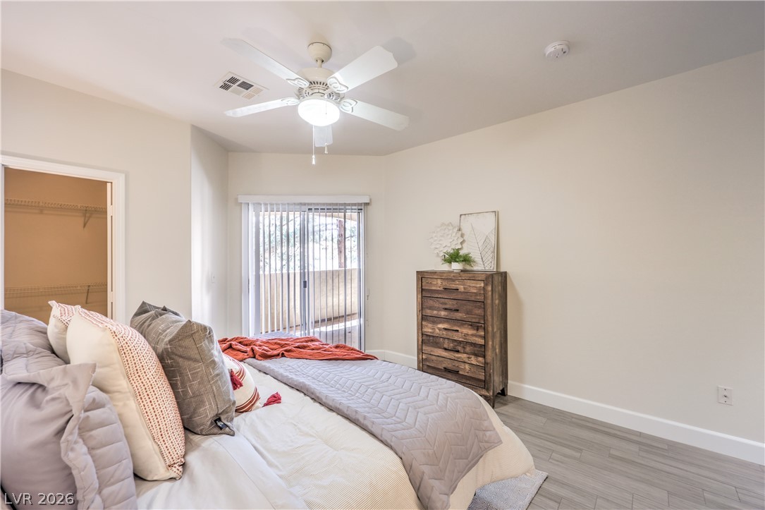 2050 West Warm Springs Road, Unit 1421 Henderson, NV 89014 - Photo 21 of 45 A well-lit primary bedroom offers serene comfort with direct access to a private outdoor space.