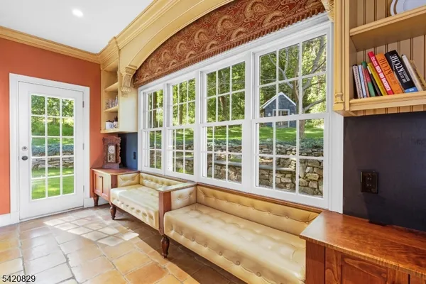 a living room with furniture and floor to ceiling windows