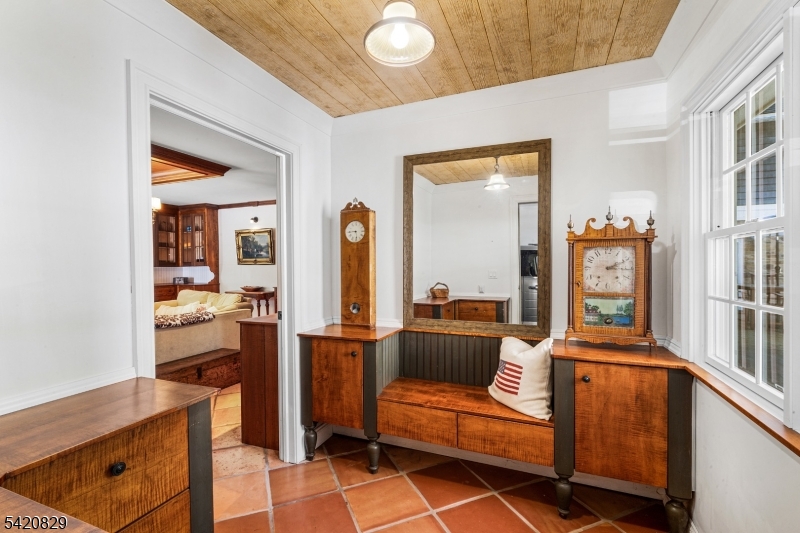 3 Laurel Lane Chester, NJ 07930 - Photo 14 of 37 a living room with furniture a flat screen tv and a refrigerator