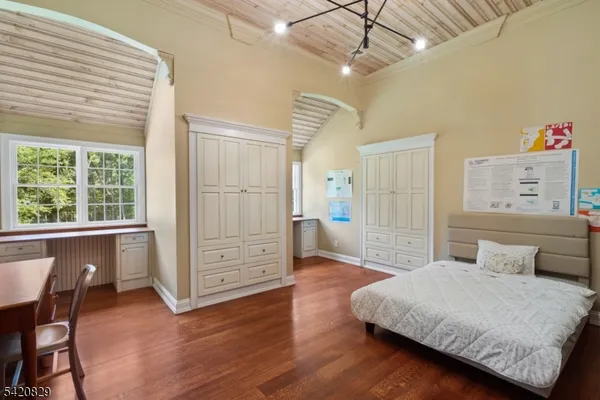 a bedroom with furniture and a wooden floor
