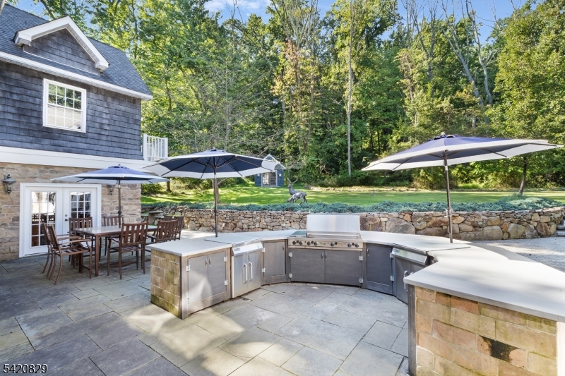 3 Laurel Lane Chester, NJ 07930 - Photo 5 of 37 a view of a patio with table and chairs under an umbrella