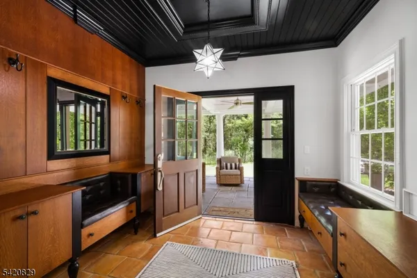 a kitchen with stainless steel appliances a stove a sink a counter top space and living room view