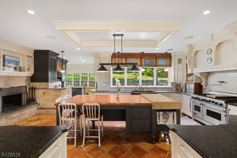 3 Laurel Lane Chester, NJ 07930 - Photo 10 of 37 a kitchen with stainless steel appliances granite countertop a stove top oven a sink dishwasher and chairs with wooden floor
