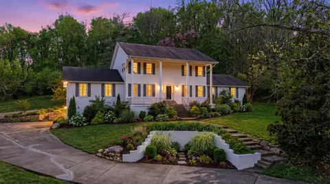 a front view of a house with a yard and outdoor seating