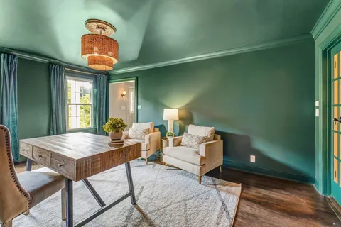 a living room with furniture a lamp and a potted plant