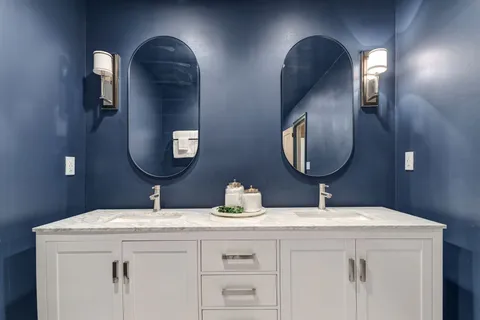 a front view of a house with a yard and garden