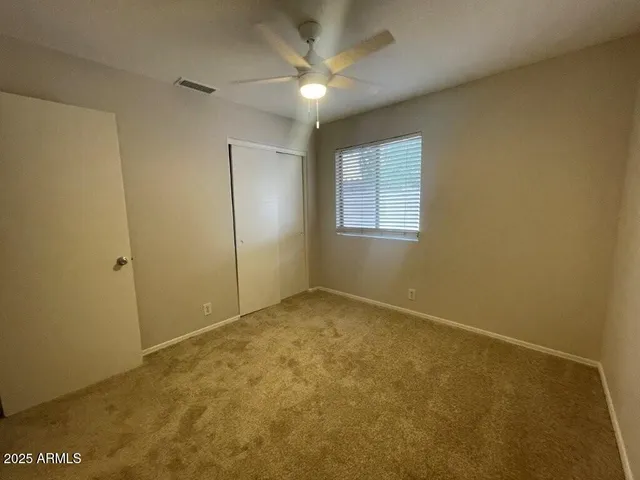 a bathroom with a granite countertop sink toilet a mirror and shower