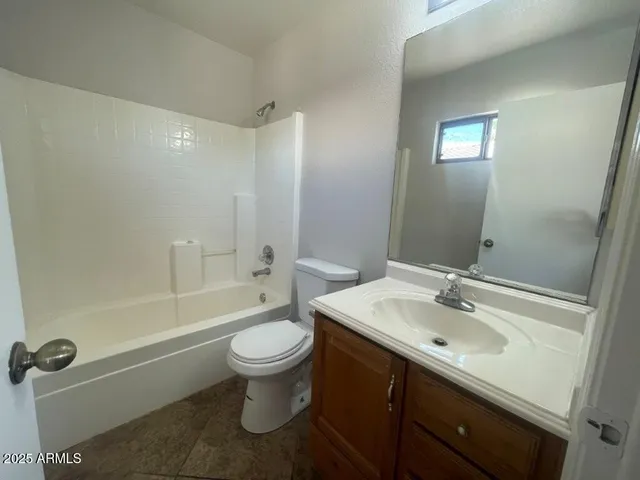 an empty room with a ceiling fan and a window