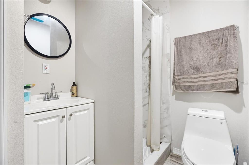 2511 West Abdella Street Tampa, FL 33607 - Photo 15 of 17 a bathroom with a toilet a sink and a mirror