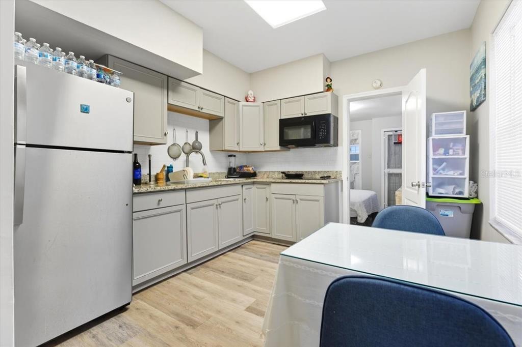 2511 West Abdella Street Tampa, FL 33607 - Photo 3 of 17 a kitchen with white cabinets and white appliances