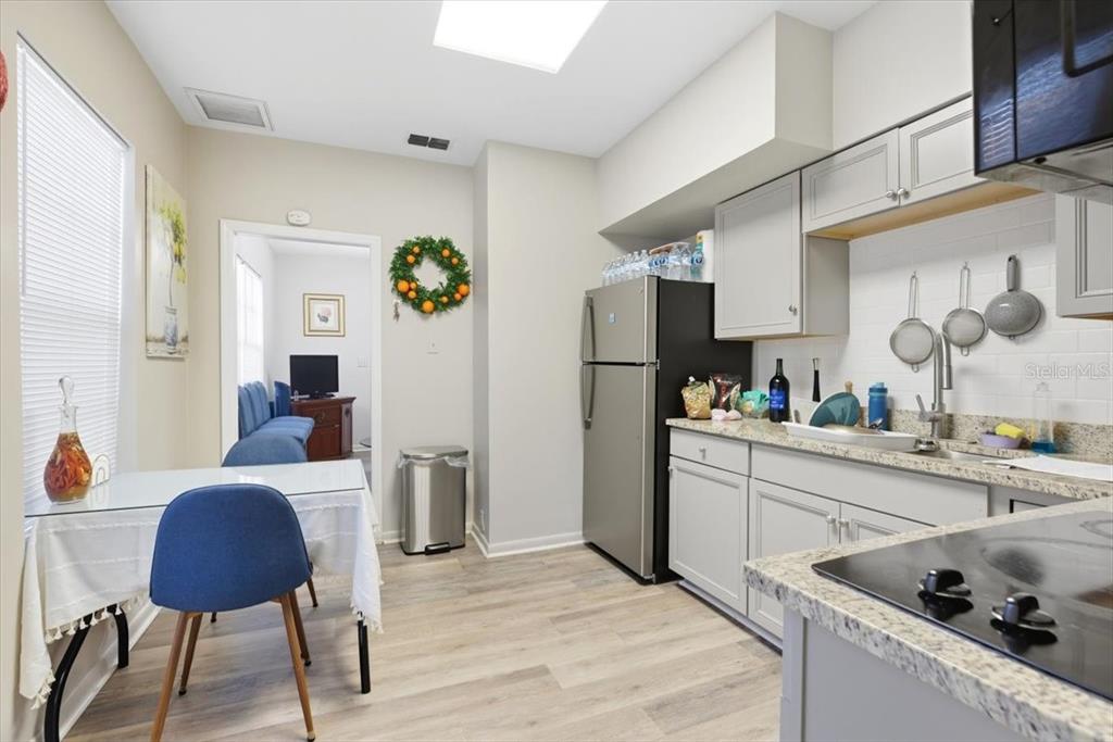 2511 West Abdella Street Tampa, FL 33607 - Photo 4 of 17 a kitchen with stainless steel appliances kitchen island granite countertop a sink refrigerator and cabinets