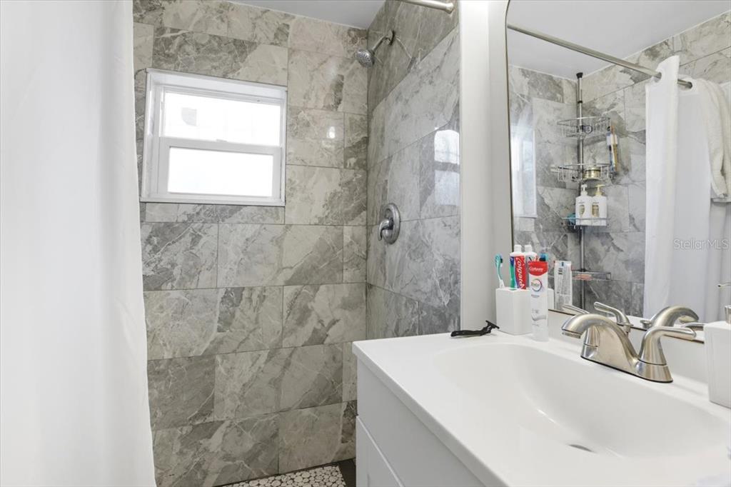2511 West Abdella Street Tampa, FL 33607 - Photo 8 of 17 a bathroom with a sink shower and a mirror