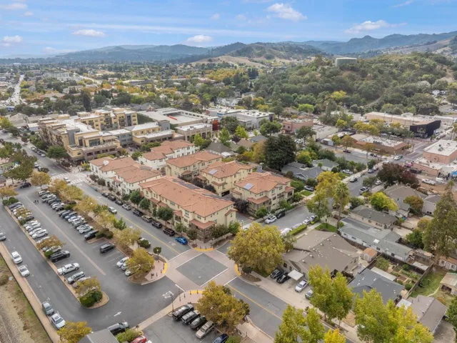 an aerial view of residential houses with outdoor space
