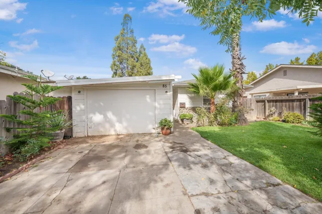 a view of a chair and table in the patio