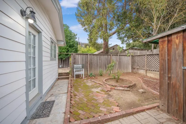 a backyard of a house with table and chairs