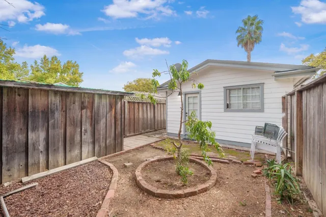 an aerial view of a house with garden space and street view