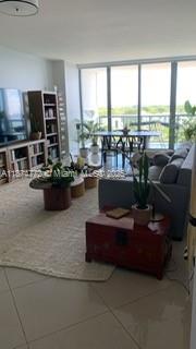 601 Northeast 36th Street, Unit 806 Miami, FL 33137 - Photo 24 of 28 a living room with furniture and a flat screen tv
