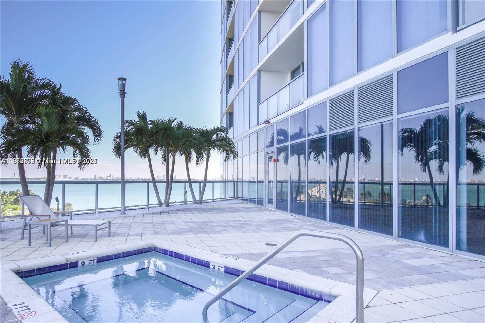 601 Northeast 36th Street, Unit 806 Miami, FL 33137 - Photo 7 of 28 a backyard of a house with palm trees