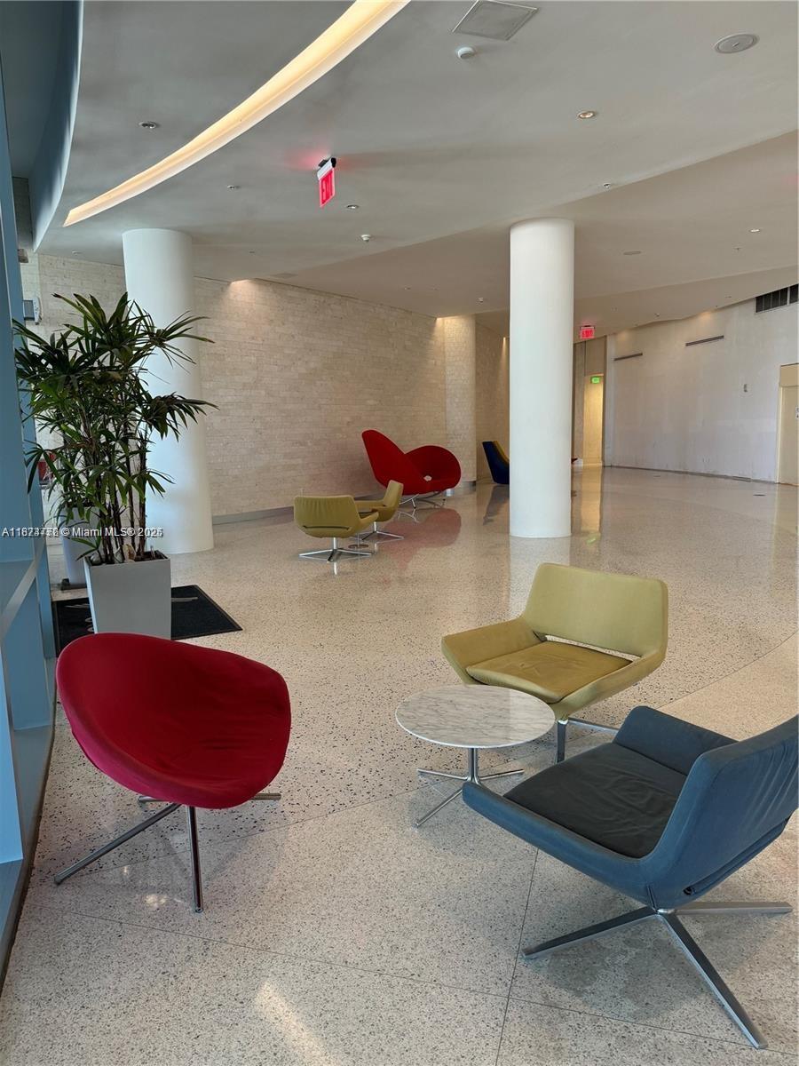 601 Northeast 36th Street, Unit 806 Miami, FL 33137 - Photo 10 of 28 a room with furniture and a potted plant